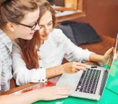 Two,Young,Women,Looking,At,Computer