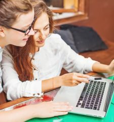 Two,Young,Women,Looking,At,Computer